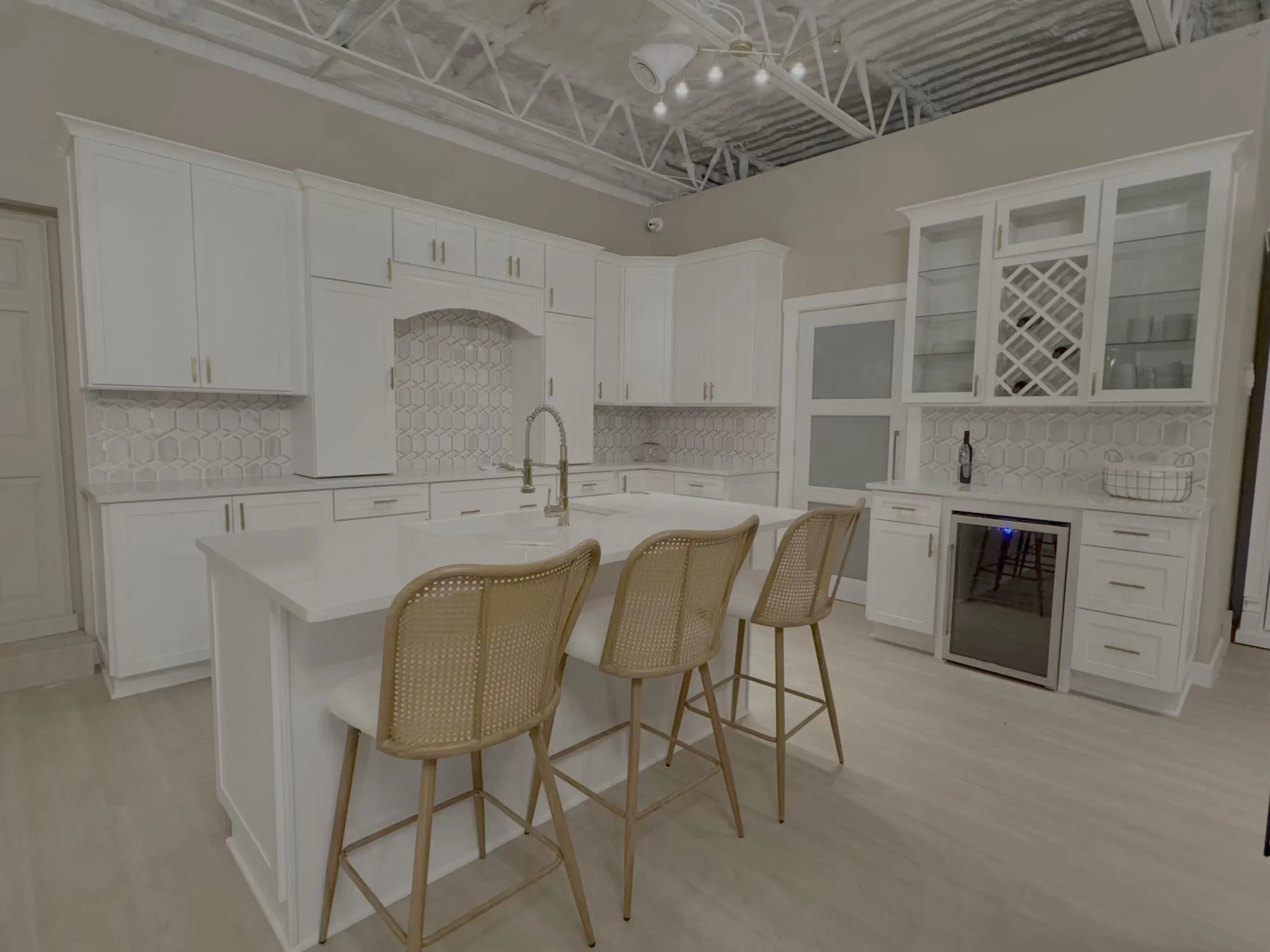 White shaker kitchen display with island seating at Steel Valley Showroom